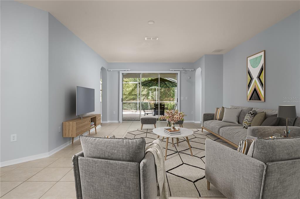 8231 Southwest 79th Court Ocala, FL 34476 - Photo 8 of 39 a living room with furniture and a flat screen tv