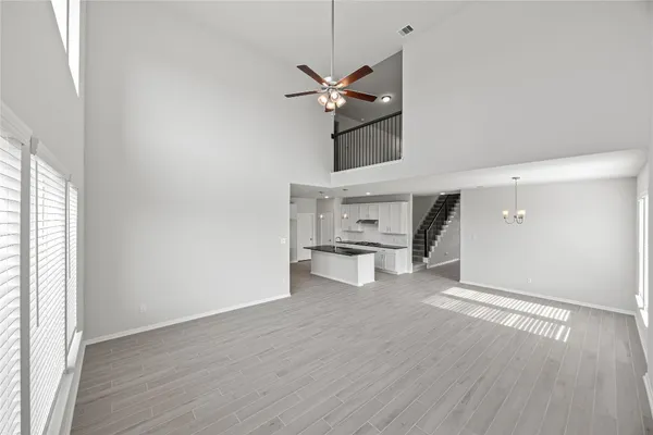a view of a kitchen with a sink and dishwasher a refrigerator with wooden floor