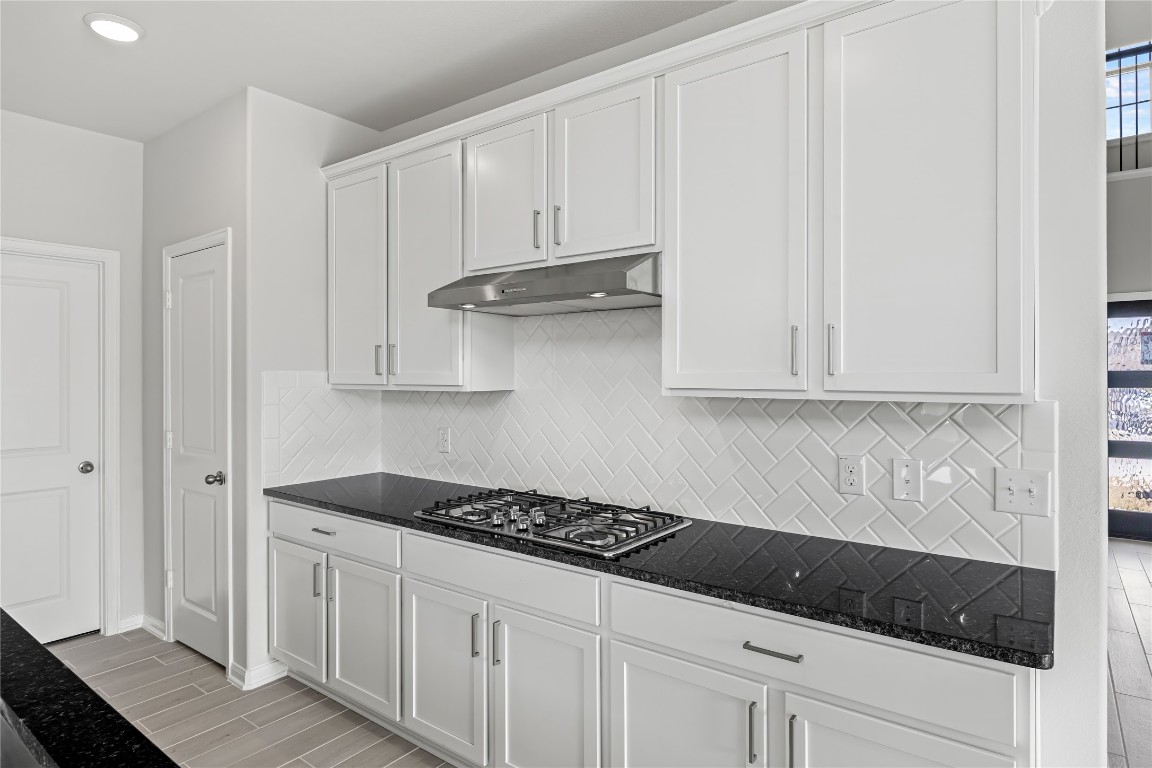 648 Canadian Trail Dayton, TX 77535 - Photo 16 of 37 a kitchen with white cabinets and sink
