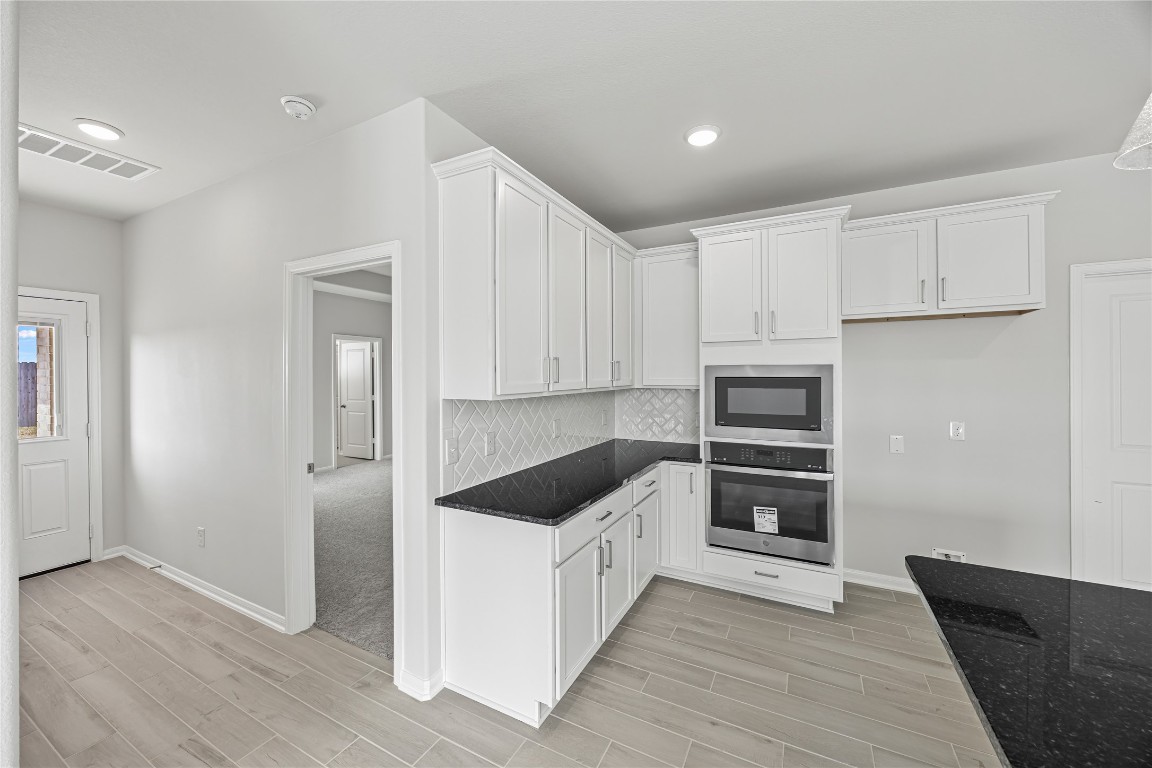 648 Canadian Trail Dayton, TX 77535 - Photo 18 of 37 a kitchen with granite countertop a refrigerator and a sink