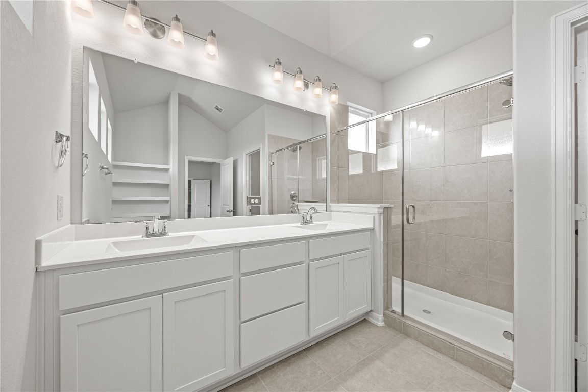 648 Canadian Trail Dayton, TX 77535 - Photo 24 of 37 a bathroom with a shower sink and mirror