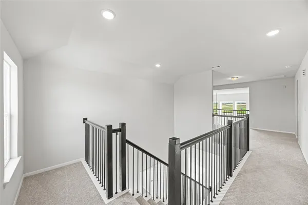 a view of a hallway with windows