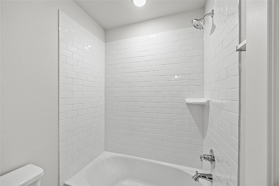 648 Canadian Trail Dayton, TX 77535 - Photo 33 of 37 a bathroom with a shower and toilet