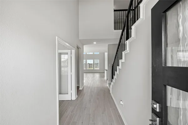 a view of entryway with wooden floor and stairs