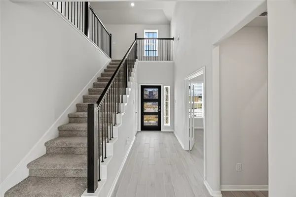 a view of entryway and hall with wooden floor
