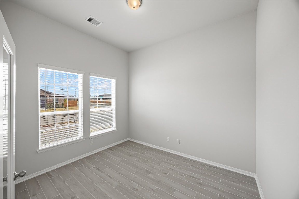 648 Canadian Trail Dayton, TX 77535 - Photo 8 of 37 an empty room with wooden floor and windows