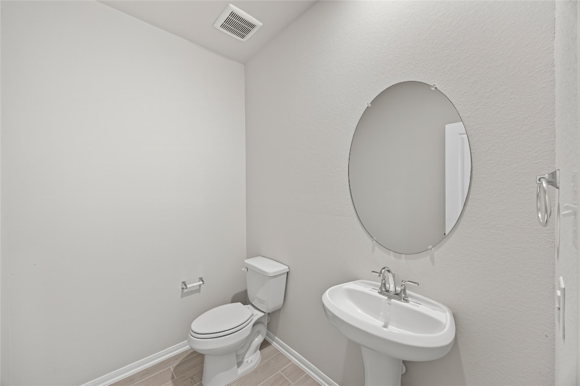 648 Canadian Trail Dayton, TX 77535 - Photo 9 of 37 a bathroom with a toilet sink and mirror