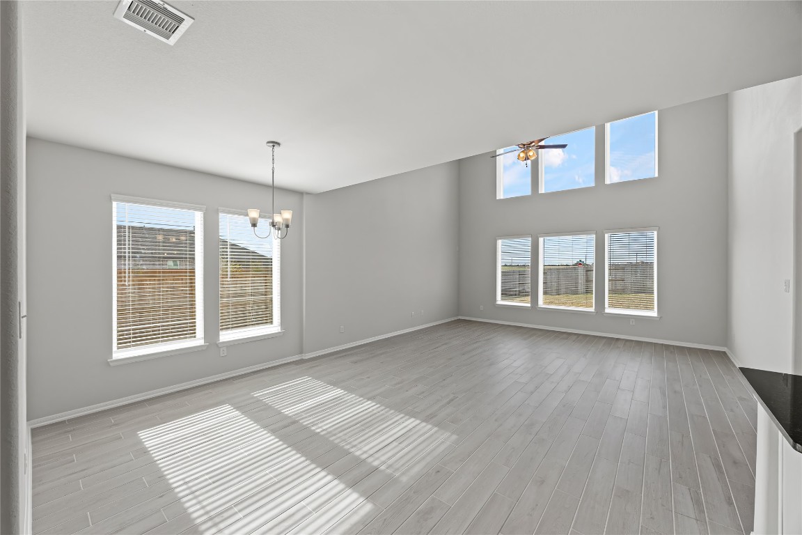 648 Canadian Trail Dayton, TX 77535 - Photo 10 of 37 a view of an empty room with a window and wooden floor