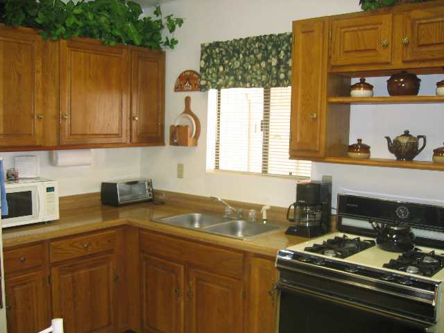 2052 Shot Gun Road Overgaard, AZ 85933 - Photo 3 of 5 a kitchen with a sink stove and cabinets