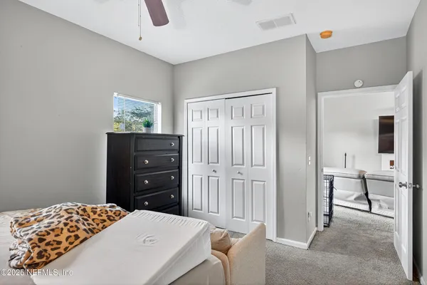 a bedroom with a bed and a dresser