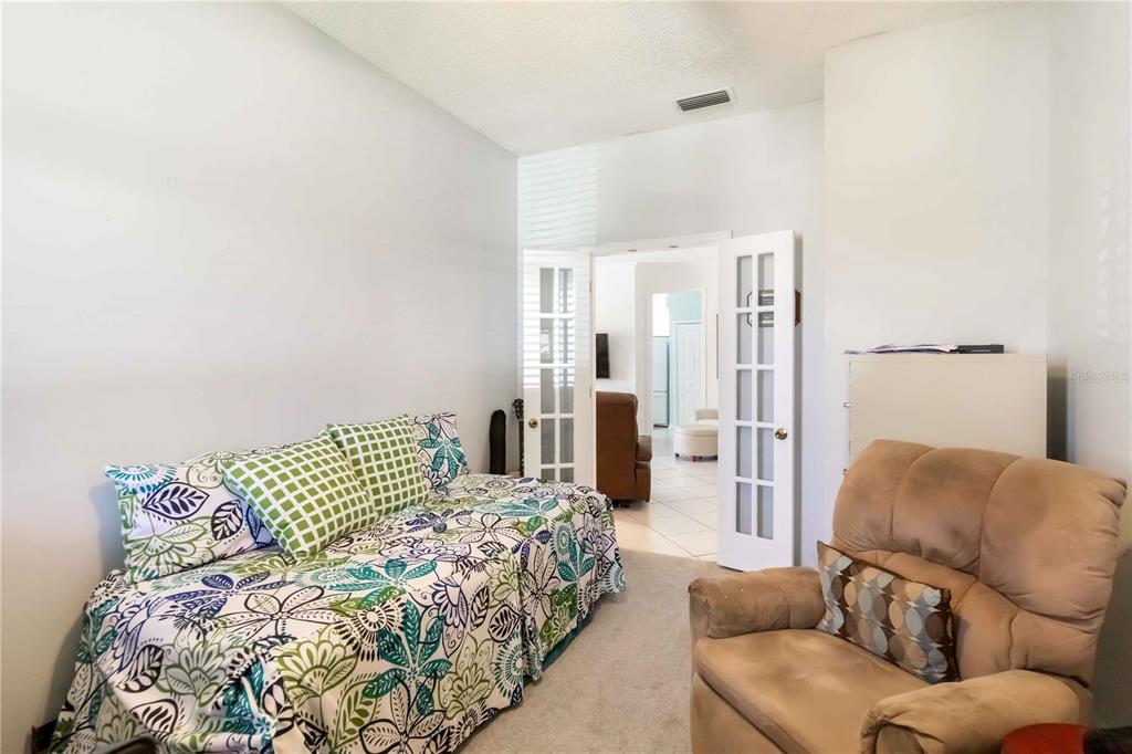 357 Fareham Drive Venice, FL 34293 - Photo 17 of 34 a spacious bedroom with a bed and a couch