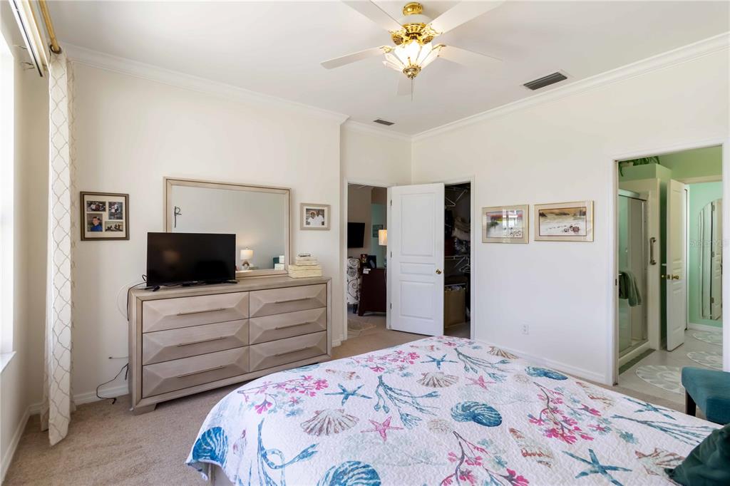 357 Fareham Drive Venice, FL 34293 - Photo 19 of 34 a bedroom with a bed and a flat screen tv