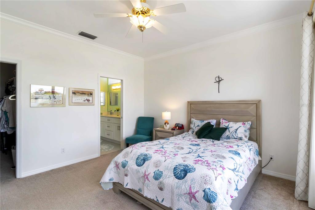 357 Fareham Drive Venice, FL 34293 - Photo 20 of 34 a bedroom with a bed and a chandelier