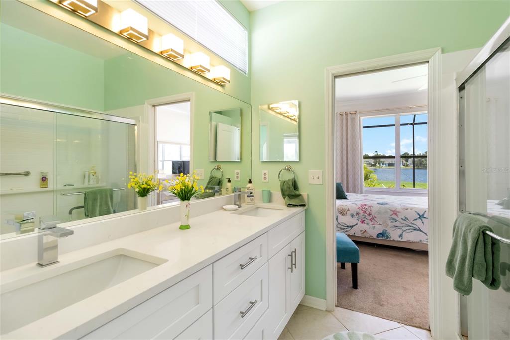 357 Fareham Drive Venice, FL 34293 - Photo 21 of 34 a en suite bathroom with a double vanity sink and a mirror