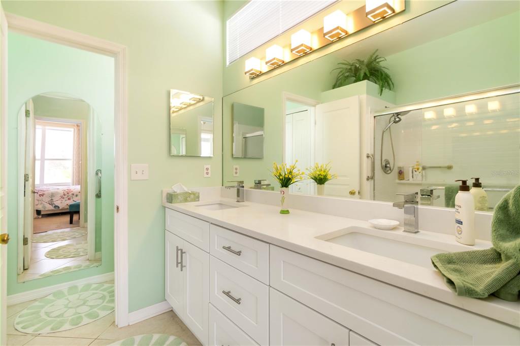 357 Fareham Drive Venice, FL 34293 - Photo 23 of 34 a en suite bathroom with a granite countertop sink and a mirror