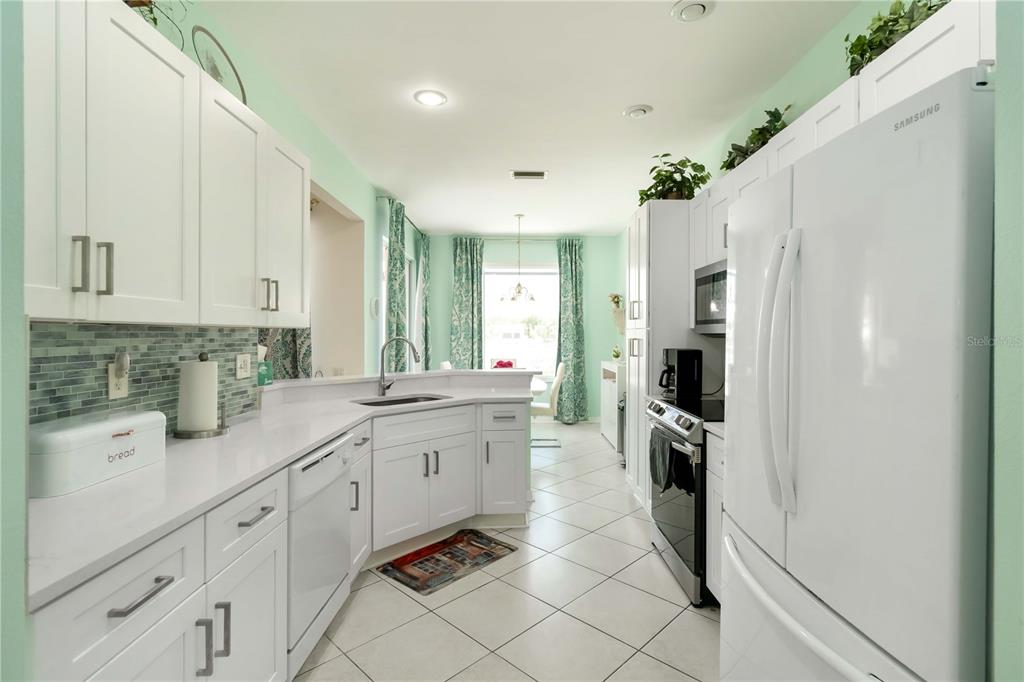 357 Fareham Drive Venice, FL 34293 - Photo 10 of 34 a kitchen with white cabinets and appliances