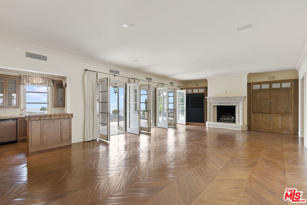 16375 Shadow Mountain Drive Pacific Palisades, CA 90272 - Photo 16 of 50 a view of an empty room with window and wooden floor