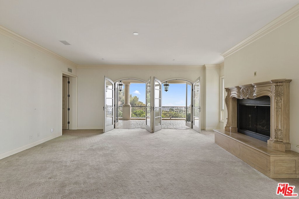 16375 Shadow Mountain Drive Pacific Palisades, CA 90272 - Photo 26 of 50 a view of an empty room with a fireplace and a window