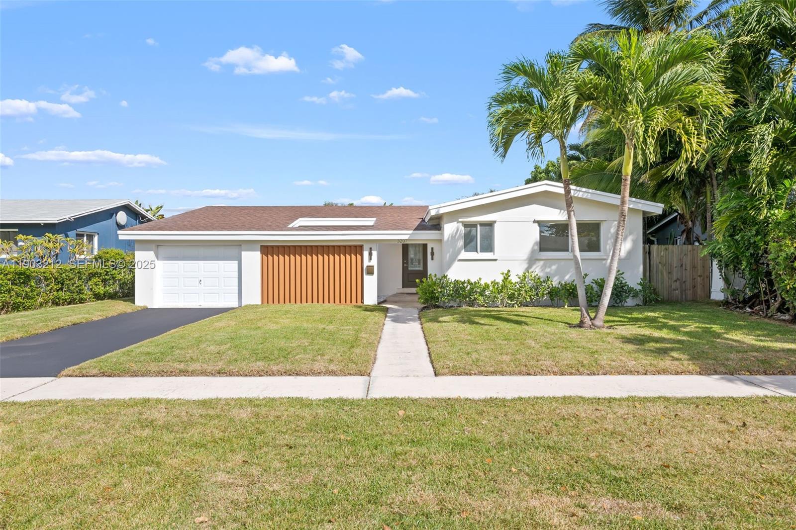 3207 Wilson Street Hollywood, FL 33021 - Photo 1 of 18 a view of a house with backyard and tree