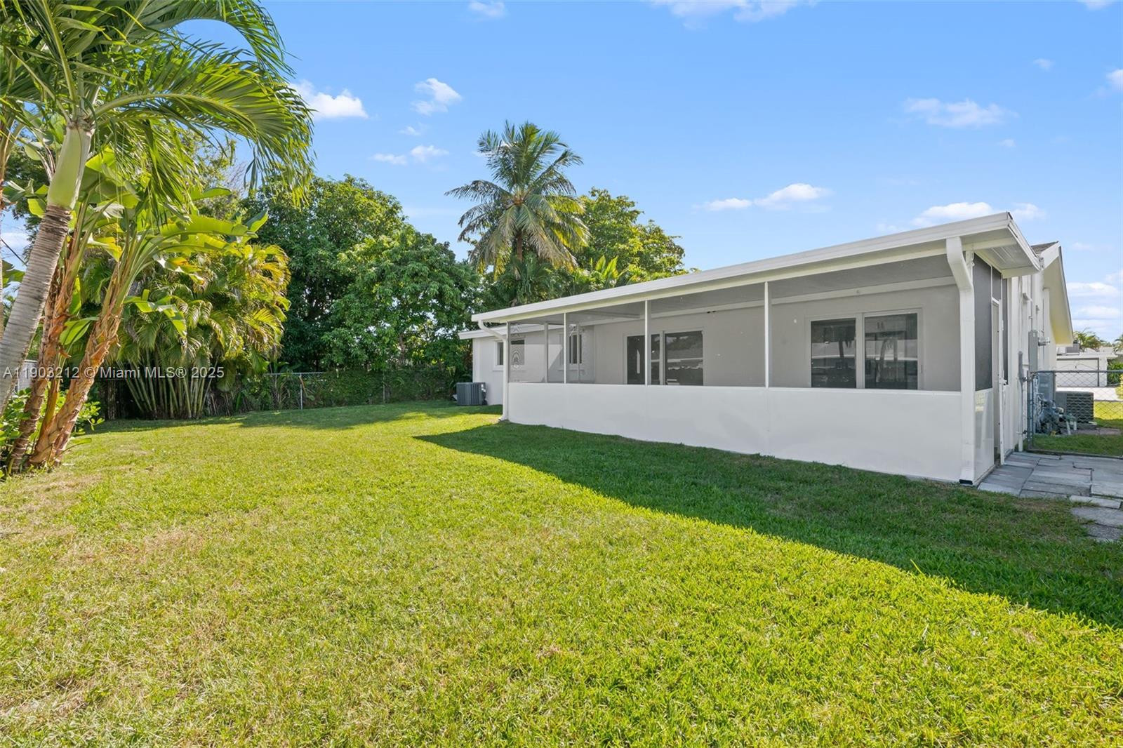 3207 Wilson Street Hollywood, FL 33021 - Photo 17 of 18 a view of a backyard with plants and large trees