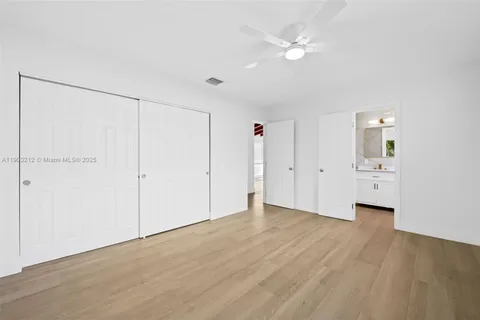 a bathroom with a granite countertop sink a mirror and shower
