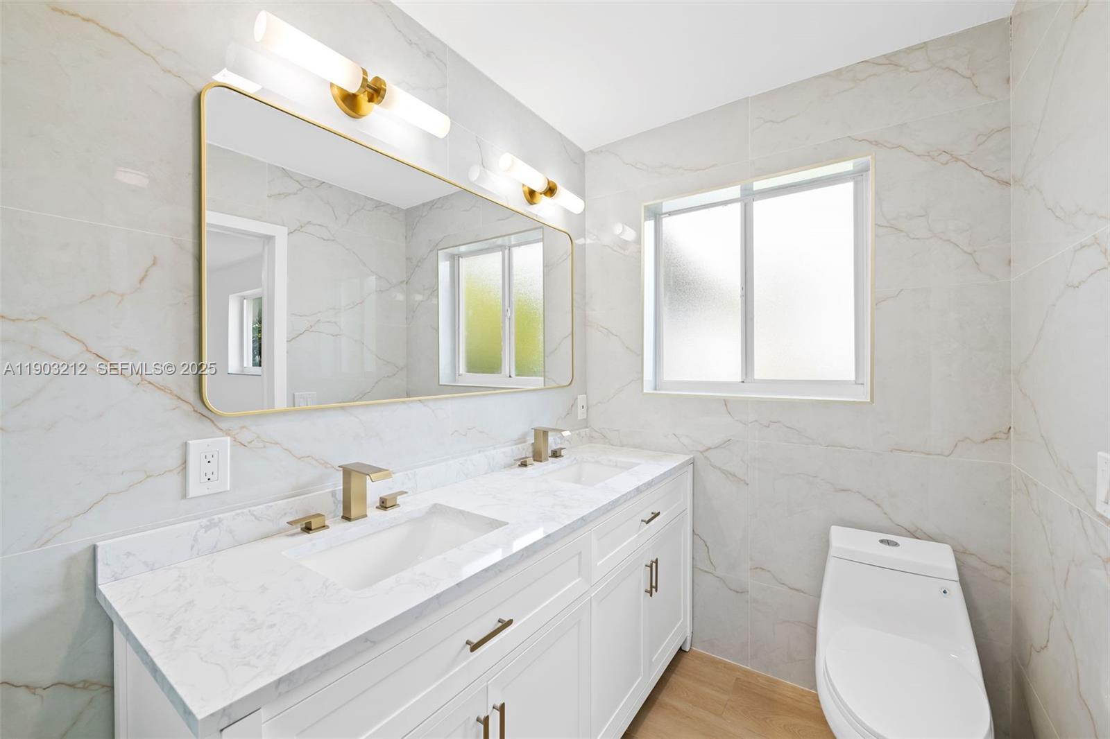 3207 Wilson Street Hollywood, FL 33021 - Photo 10 of 18 a bathroom with a sink toilet vanity and mirror