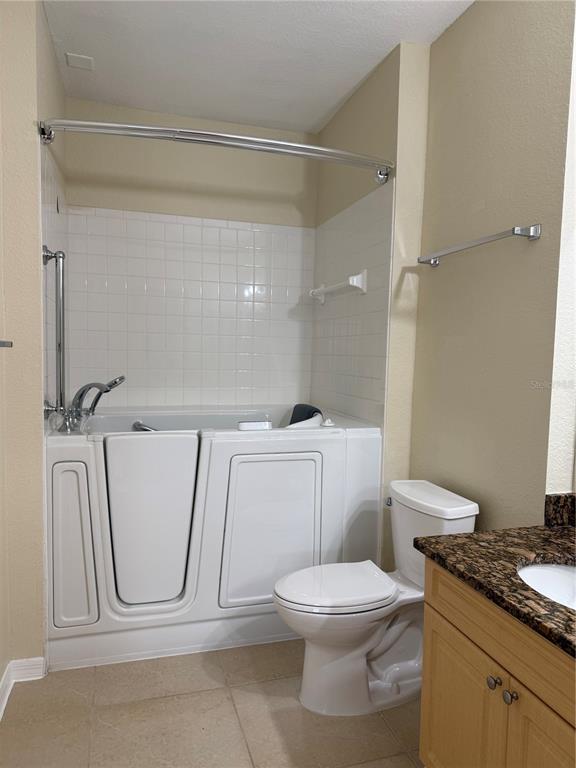 3725 Conroy Road, Unit 2127 Orlando, FL 32839 - Photo 18 of 30 a white toilet sitting next to a bathroom sink