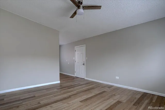 a view of a room with wooden floor
