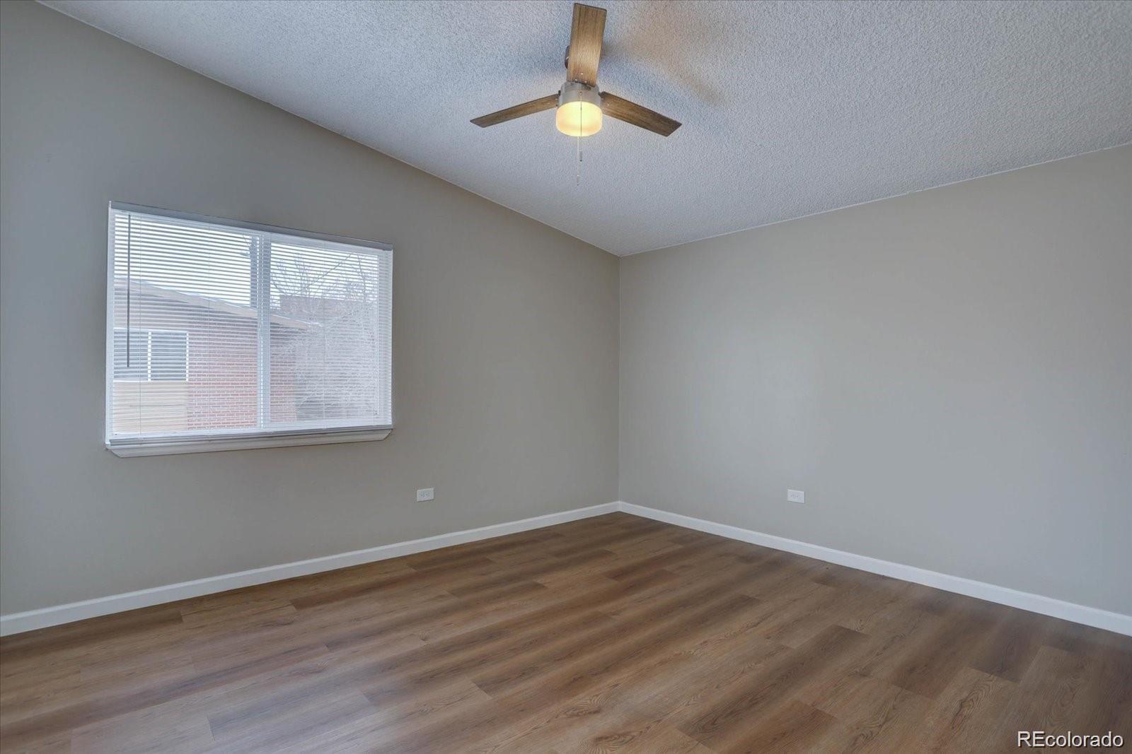 2938 Eliot Circle, Unit 2 Westminster, CO 80030 - Photo 20 of 28 a view of empty room with wooden floor and fan
