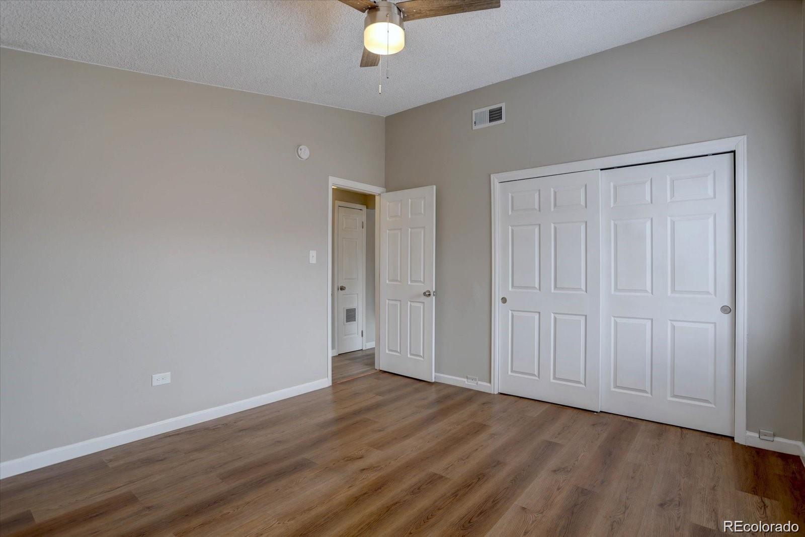 2938 Eliot Circle, Unit 2 Westminster, CO 80030 - Photo 21 of 28 a view of an empty room with wooden floor
