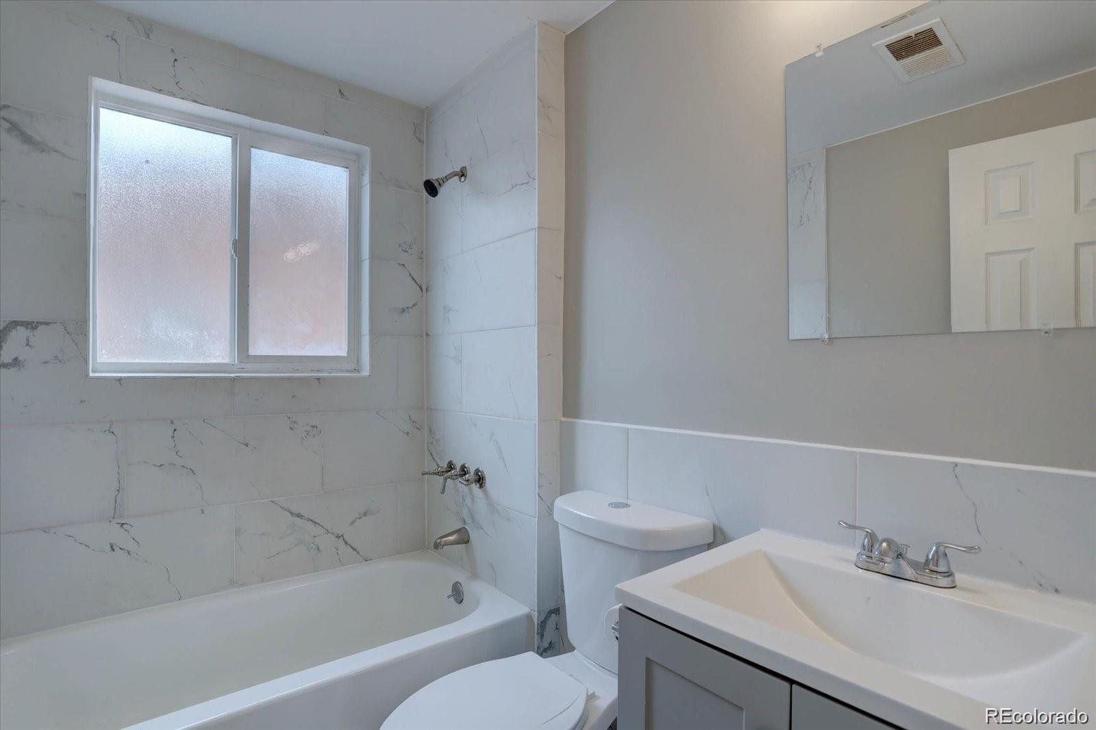 2938 Eliot Circle, Unit 2 Westminster, CO 80030 - Photo 22 of 28 a bathroom with a sink toilet and shower