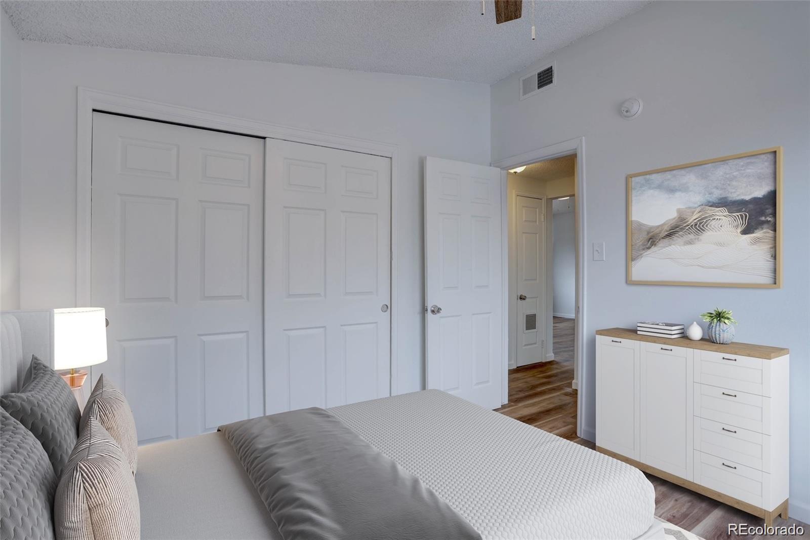 2938 Eliot Circle, Unit 2 Westminster, CO 80030 - Photo 3 of 28 a bedroom with a bed and a desk