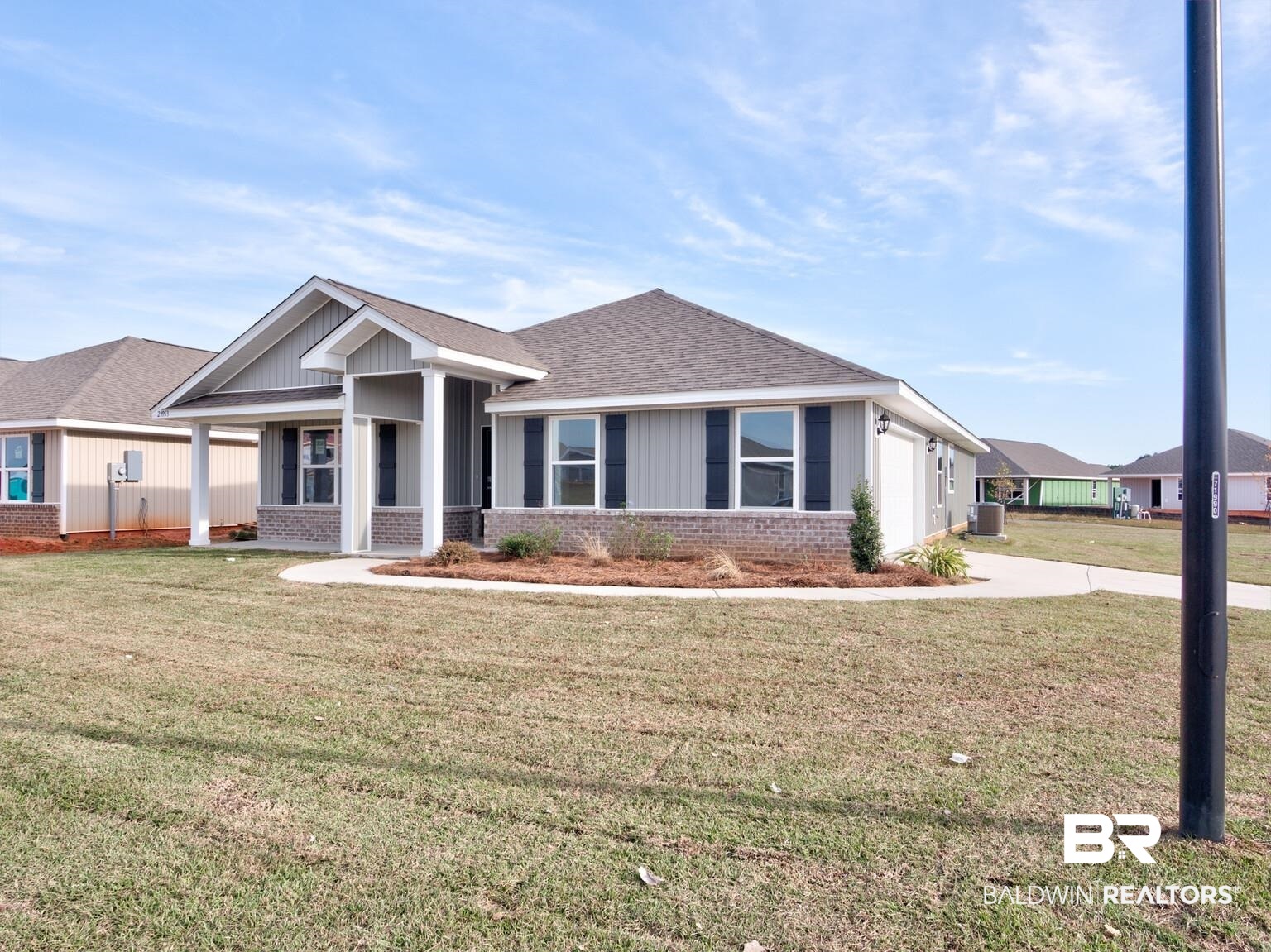 23953 Citation Loop Daphne, AL 36526 - Photo 4 of 49 View of front of house with brick siding, a front lawn, a shingled roof, covered porch, and concrete driveway
