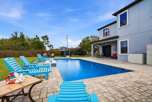 a kitchen with stainless steel appliances granite countertop a sink a stove and a wooden cabinets