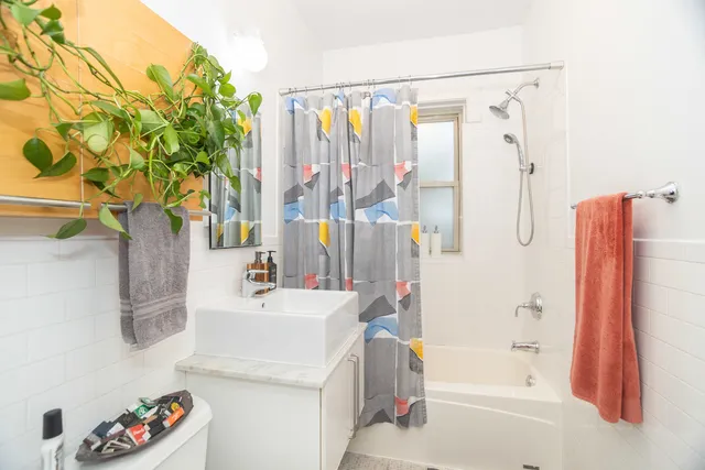 a bathroom with a sink a mirror and shower