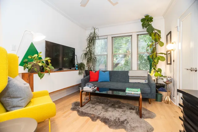 a living room with furniture a rug and a flat screen tv