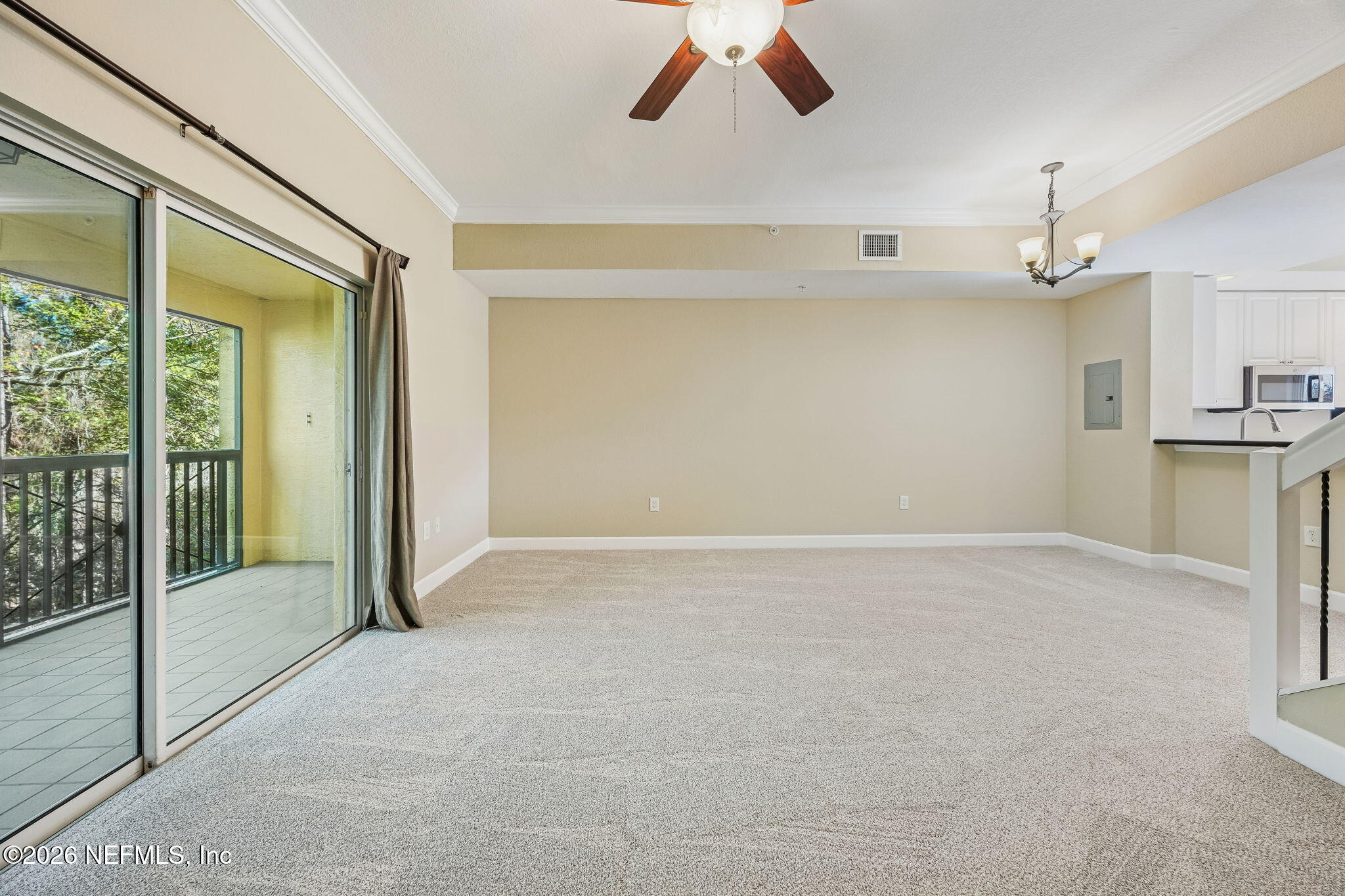 9745 Touchton Road, Unit 2125 Jacksonville, FL 32246 - Photo 20 of 50 a view of a livingroom with a ceiling fan and window