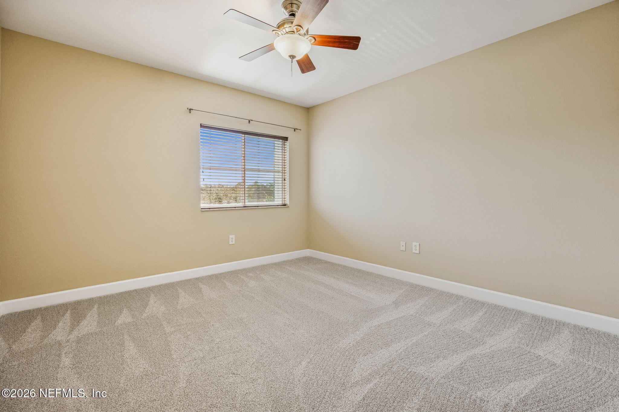 9745 Touchton Road, Unit 2125 Jacksonville, FL 32246 - Photo 22 of 50 an empty room with a window and a ceiling fan