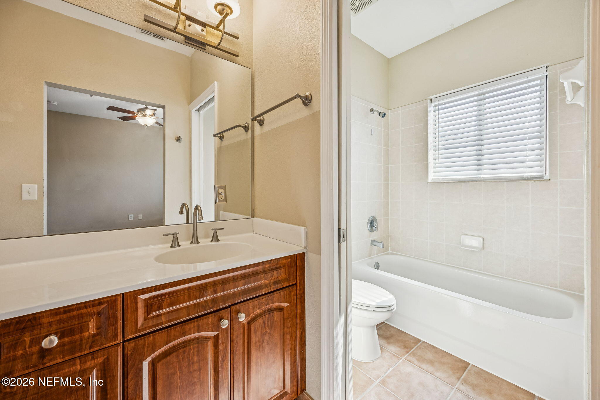 9745 Touchton Road, Unit 2125 Jacksonville, FL 32246 - Photo 27 of 50 a bathroom with a granite countertop sink toilet and shower