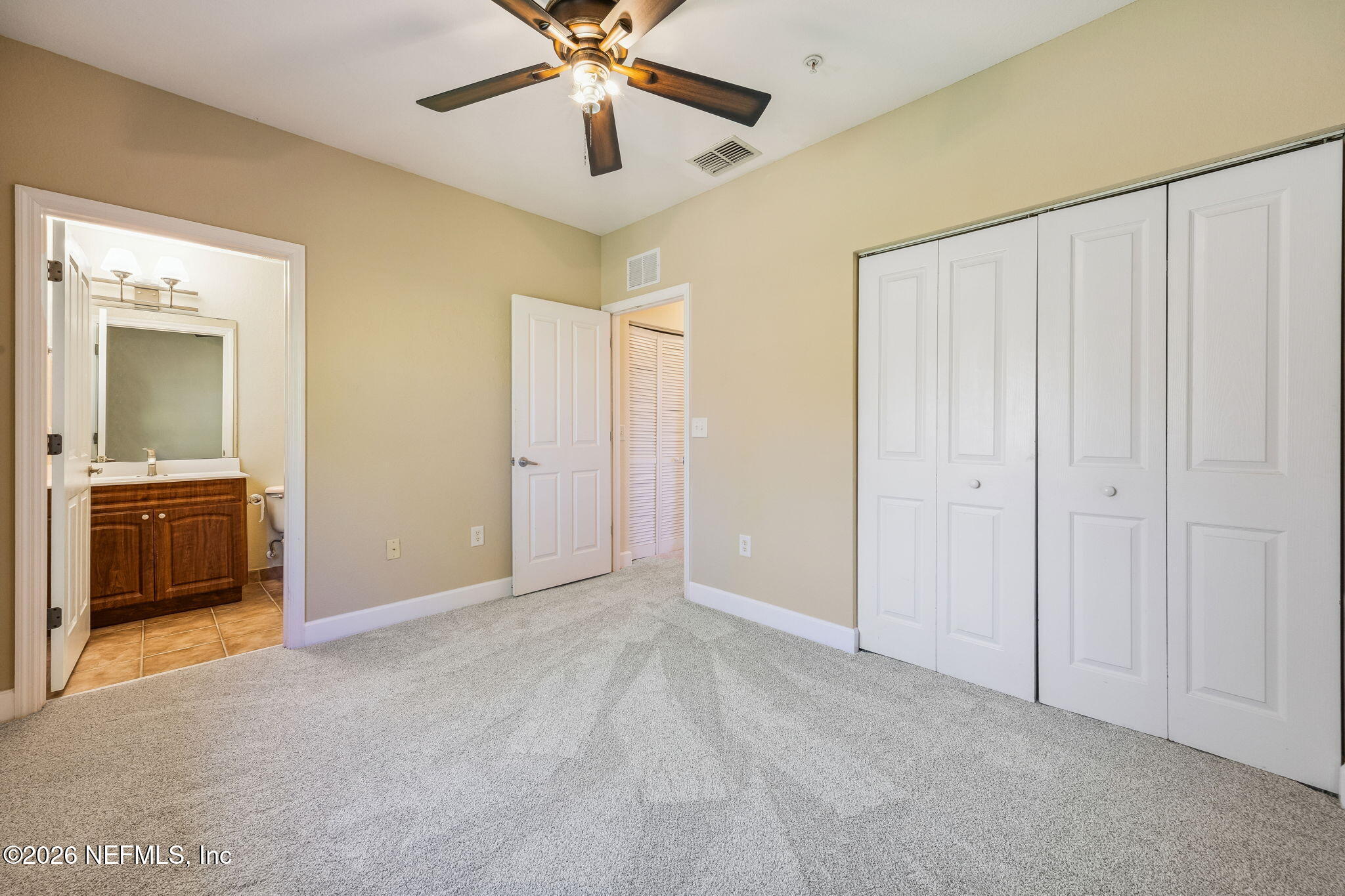 9745 Touchton Road, Unit 2125 Jacksonville, FL 32246 - Photo 29 of 50 a view of a livingroom with a chandelier fan and a bathroom