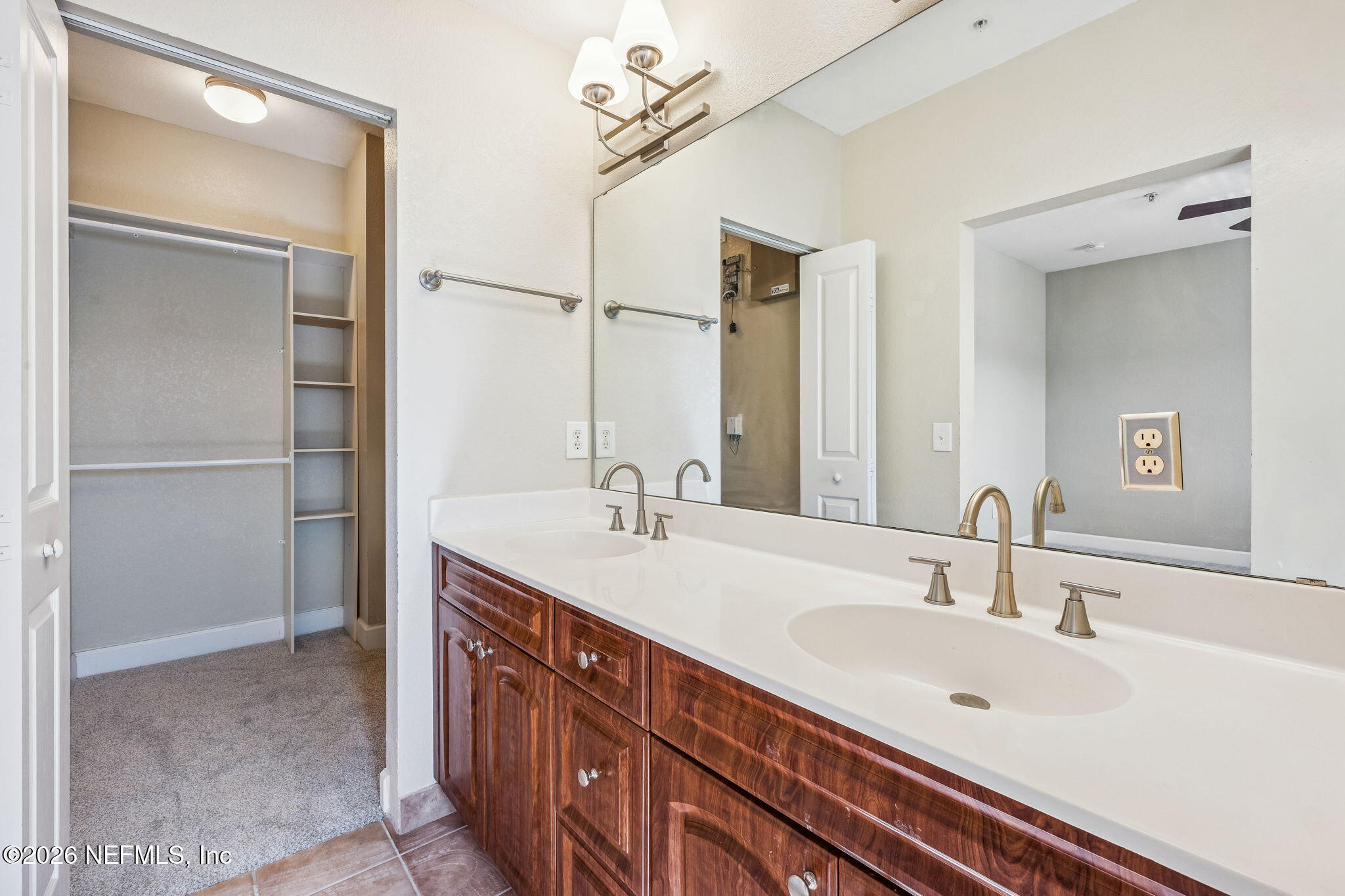 9745 Touchton Road, Unit 2125 Jacksonville, FL 32246 - Photo 32 of 50 a bathroom with a double vanity sink and a mirror