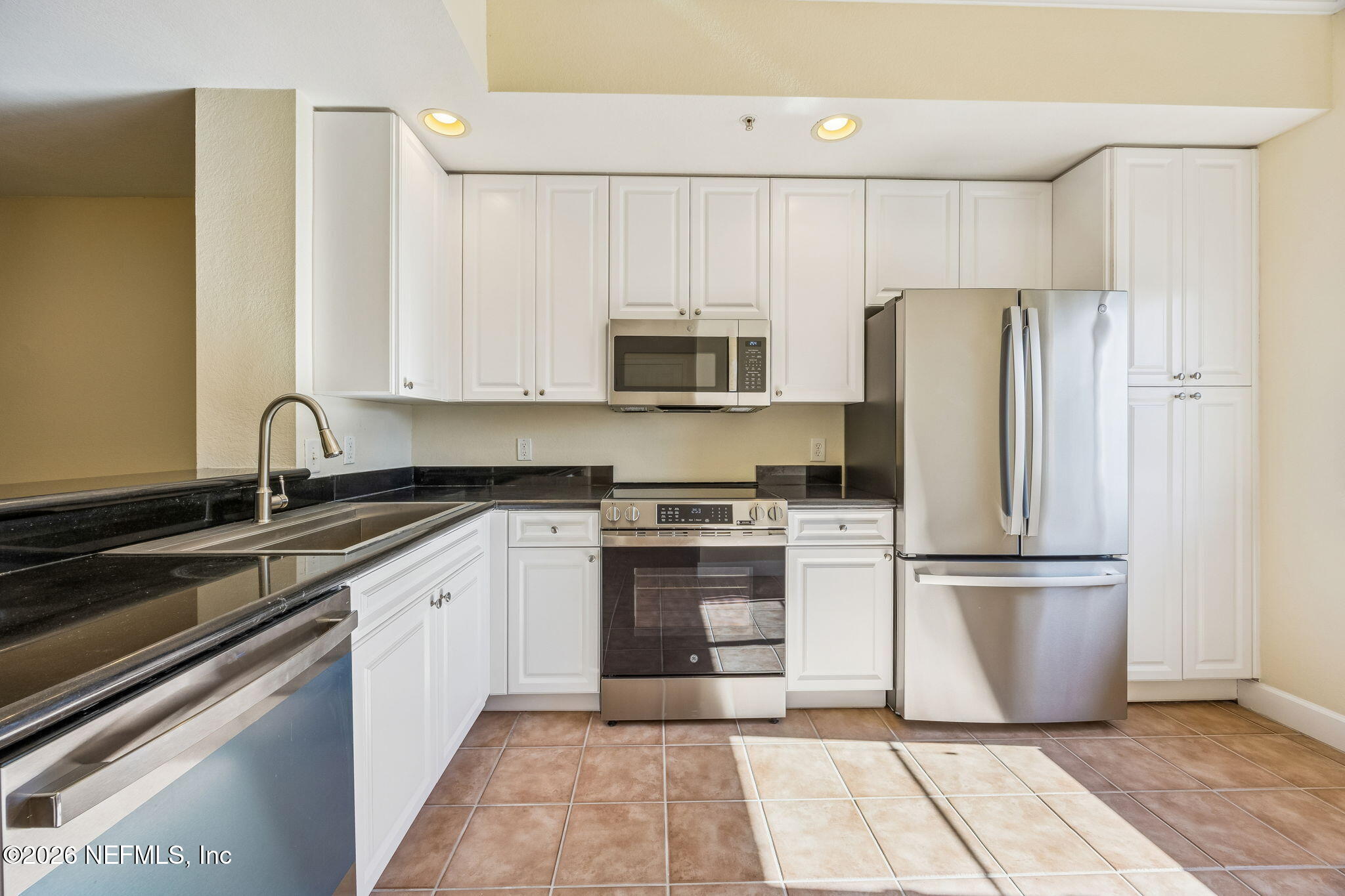 9745 Touchton Road, Unit 2125 Jacksonville, FL 32246 - Photo 10 of 50 a kitchen with a refrigerator sink and microwave