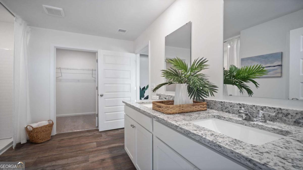 149 Timber Road Statesboro, GA 30458 - Photo 24 of 42 a bathroom with a granite countertop sink a potted plant and a window