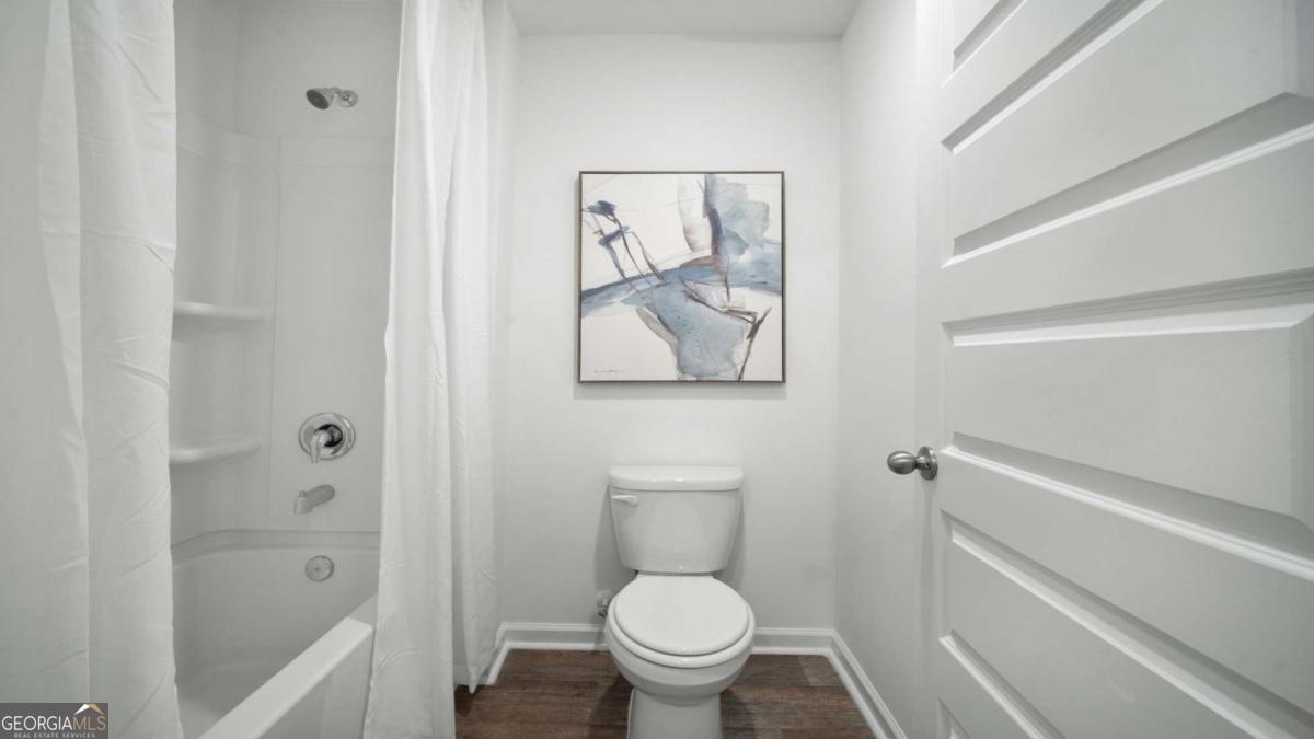 149 Timber Road Statesboro, GA 30458 - Photo 35 of 42 a white toilet sitting next to a bathroom sink and tub
