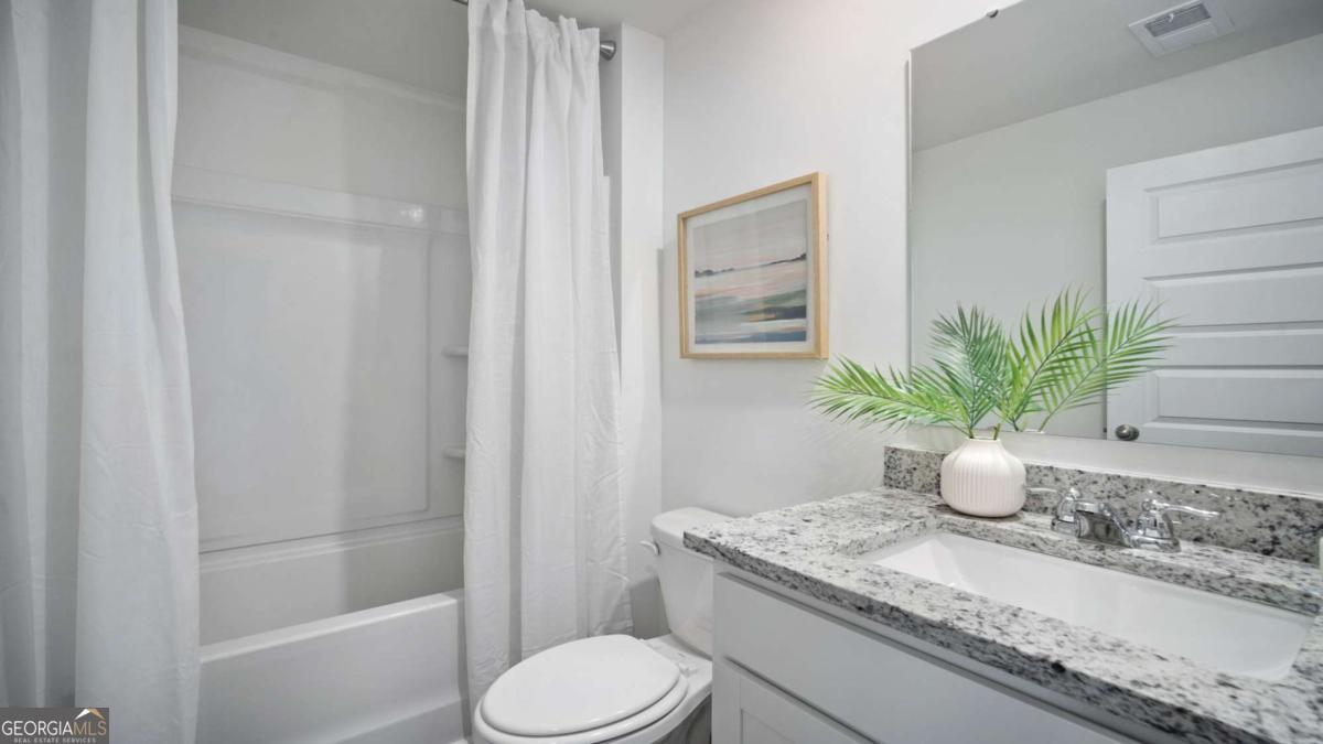 149 Timber Road Statesboro, GA 30458 - Photo 39 of 42 a bathroom with a granite countertop sink a toilet and shower