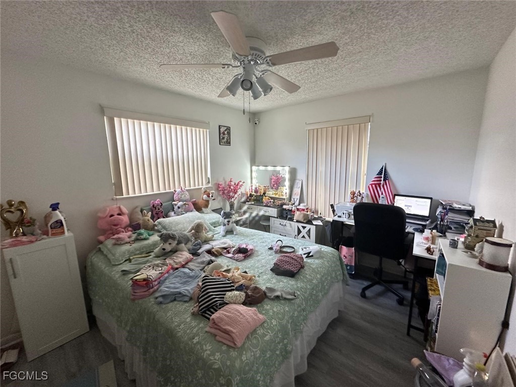 19 Pinewood Boulevard Lehigh Acres, FL 33936 - Photo 11 of 25 a bed room with a bed furniture and a window