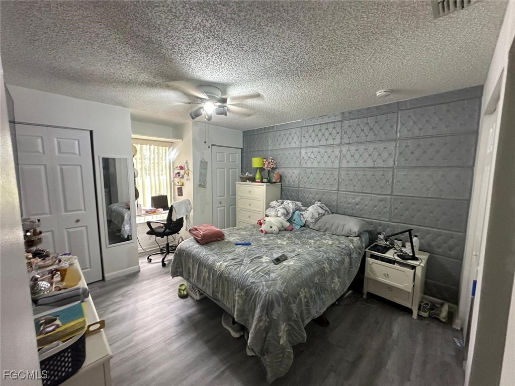 19 Pinewood Boulevard Lehigh Acres, FL 33936 - Photo 16 of 25 a bedroom with bed and wooden floor