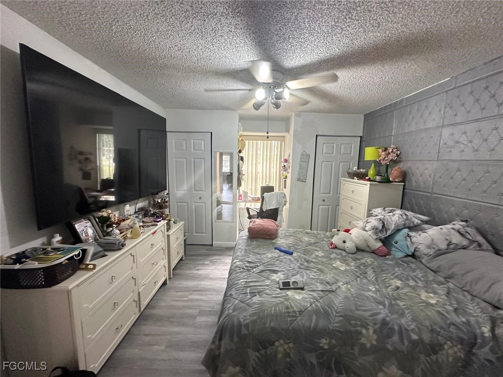 19 Pinewood Boulevard Lehigh Acres, FL 33936 - Photo 18 of 25 a large bedroom with a bed and a large mirror on the dresser