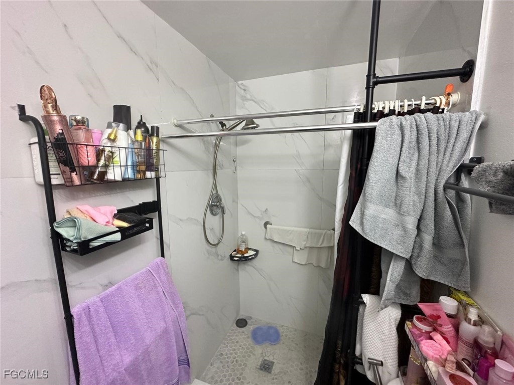 19 Pinewood Boulevard Lehigh Acres, FL 33936 - Photo 20 of 25 a bathroom with a sink and a shower curtain