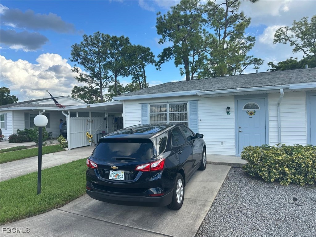 19 Pinewood Boulevard Lehigh Acres, FL 33936 - Photo 2 of 25 a house view with a garden space